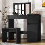 Modern black makeup dressing table with flip-up mirror, storage compartments, and matching stool for bedroom vanity setup.