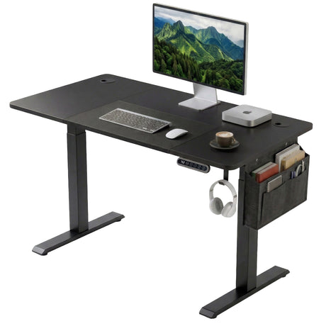 [110cm x 60cm] Electric Standing Desk Height Adjustable featuring an all-black design with a computer monitor, integrated desk mat, hanging headphones, and a grey fabric side storage pocket
