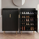 [Black] Fluted Shoe Storage Cabinet shown closed and open side-by-side in a panelled hallway with round mirror and herringbone wood floor
