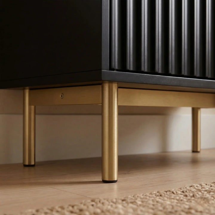 [Black] Fluted Shoe Storage Cabinet close-up of fluted door panel, gold brushed metal leg, and herringbone floor with jute rug edge