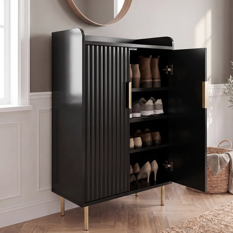 [Black] Fluted Shoe Storage Cabinet with one door open showing boots, trainers, loafers, and heels in a panelled hallway with round mirror