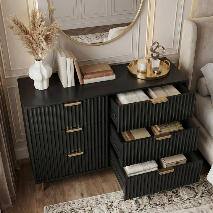 [Black] Black flutrina 6 drawer chest with right column drawers open showing folded linens, gold bar handles