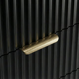 Close detail of black flutrina panel drawer front with painted metal golden handles and a unique design