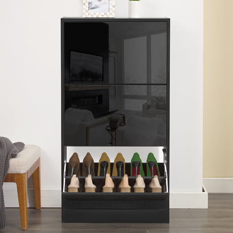 Slim shoe cabinet for hallway with its bottom drawer open in a front view, holding multiple pairs of shoes.