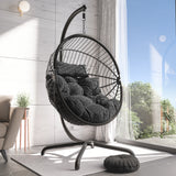 Black hanging chair with cushion in a modern room with large window