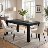 [140cm | Black] Closed table in bright dining room with four cream chairs, vase, stacked books, rug, and window light