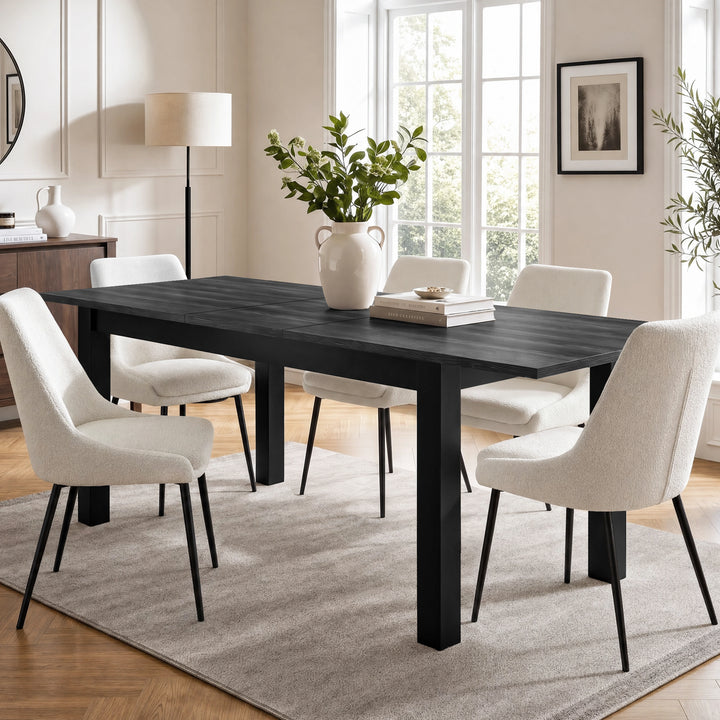 [160cm | Black] Extended table in bright dining room with six cream chairs, vase, books, rug, and soft window light