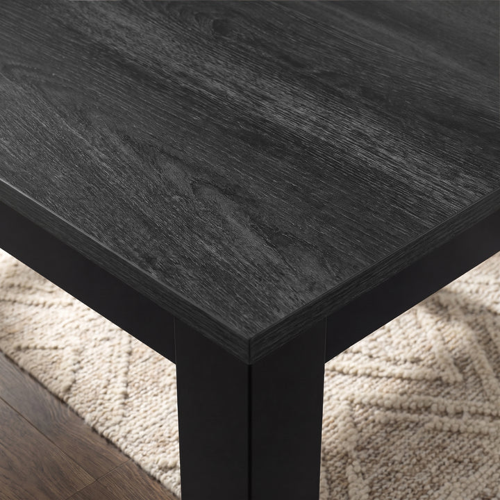 [140cm | Black] Close-up of 18mm thick Hartley extendable dining tabletop and edge, black iron frame and thick square leg