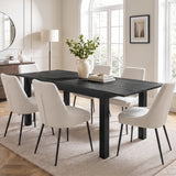 [140cm | Black] 180cm extended dining table with six cream chairs, 40cm centre leaf, leafy vase, books, dish and black frame.