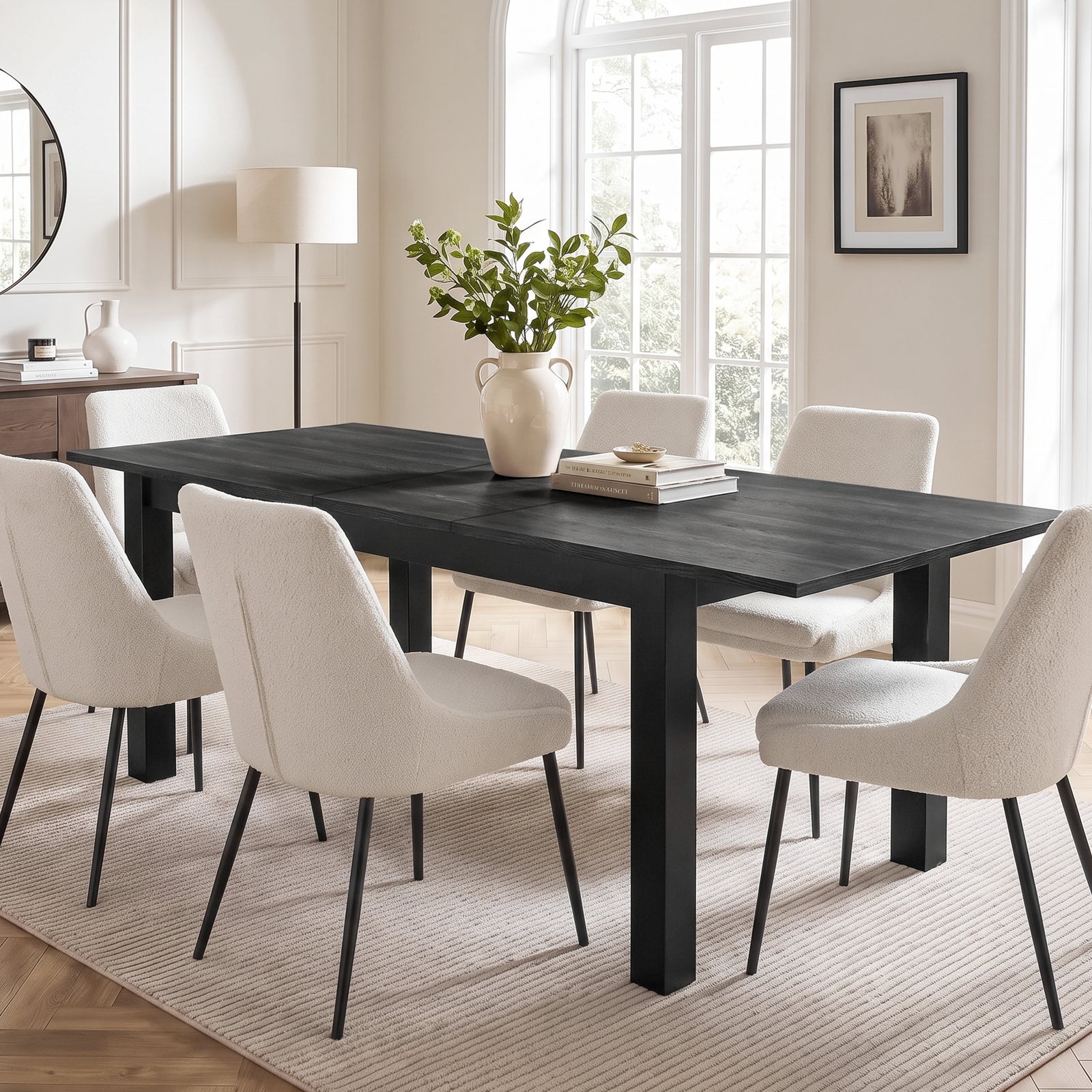 [160cm | Black] Hartley extended 200cm dining table with six cream chairs, leafy vase and books in a bright dining room.