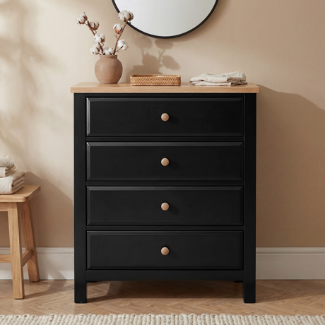 [Black] Haven 4 drawer chest styled with cotton stems in a vase, round mirror and linen textiles in a warm bedroom