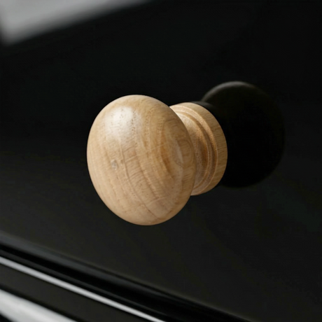 [Black] Haven chest detail showing a rounded solid oak drawer knob against the matte black painted drawer front