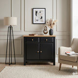 [Black] Haven Small Black Sideboard with Drawers & Oak Top, Painted Finish styled within a living room scene next to an armchair.