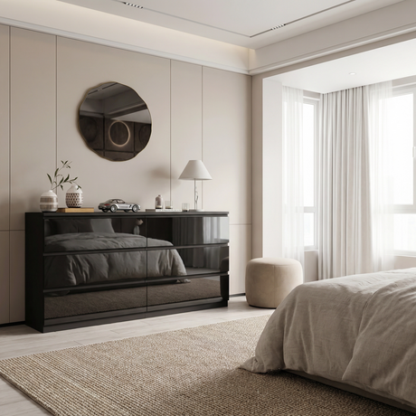 A black high gloss dresser placed against a wall with a bed, and decorative elements in a modern bedroom