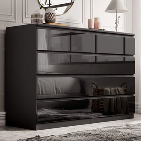 [black] high gloss 8 drawer chest in bedroom with panelled wall mirror and decorative vases