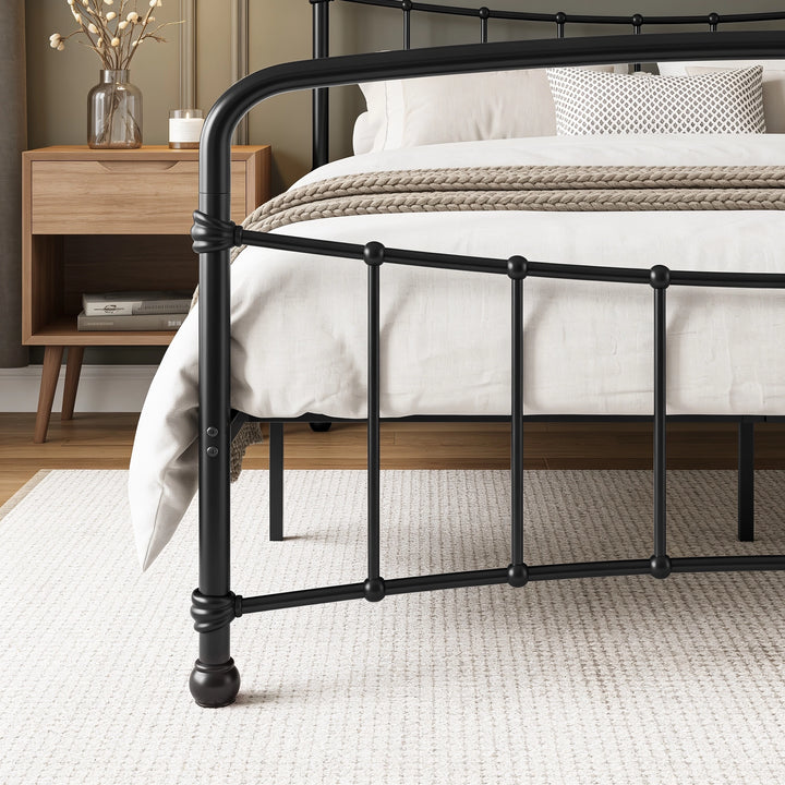 [Black | King] Footboard close-up showing curved rail, vertical bars, wrapped joints, two bolts and rounded ball foot