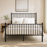 [Black | King] Front view of black metal king bed with white bedding, bar headboard and footboard, centre leg, lamp and plant