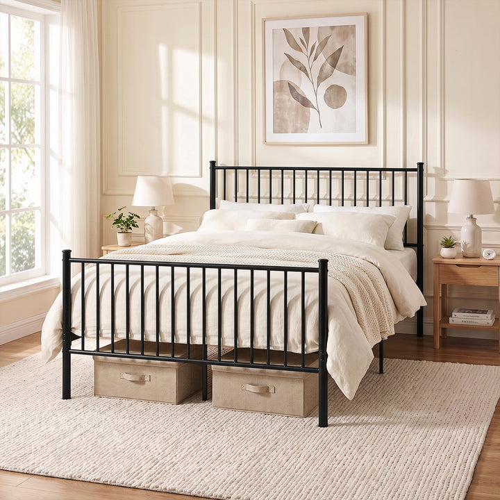[Black | King] Black metal bed with white bedding, storage boxes, wooden bedside tables, lamps and plants in a bright room.