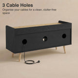 [Black | 112 cm] Larvik rear panel showing three cable management holes with power cord threaded through on beige background