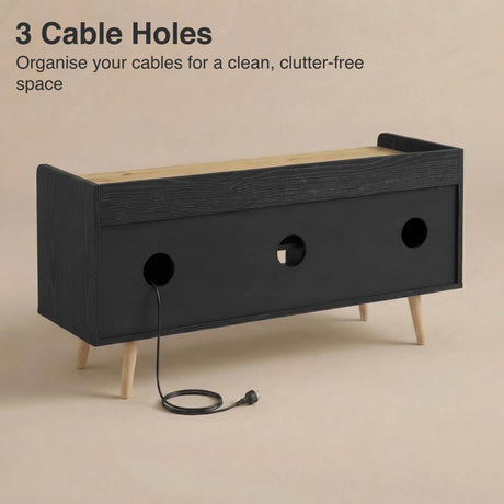[Black | 112 cm] Larvik rear panel showing three cable management holes with power cord threaded through on beige background