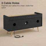 [Black | 112 cm] Larvik rear panel showing three cable management holes with power cord threaded through on beige background