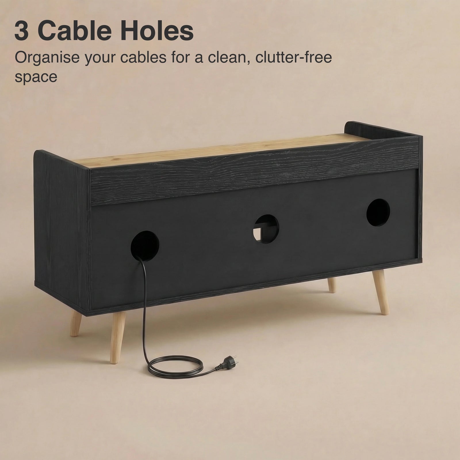 [Black | 112 cm] Larvik rear panel showing three cable management holes with power cord threaded through on beige background
