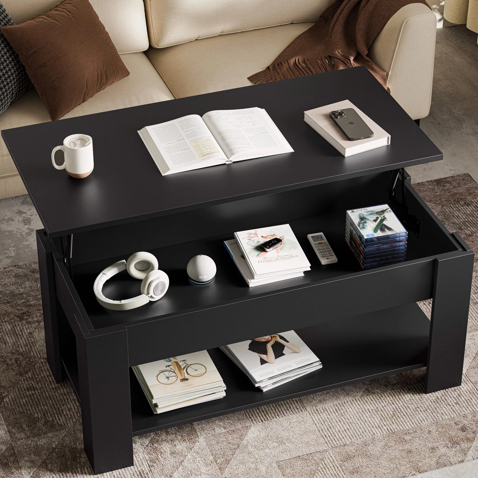 [Black] Lift top coffee table in black finish with open book on surface next to cream sofa.