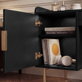 View of open shelves inside a black makeup table, showing books and accessories on display with gold legs