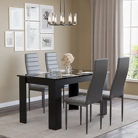 minimalist setup with dining table and chairs in grey leather, featuring a black marble high gloss table and elegant chairs
