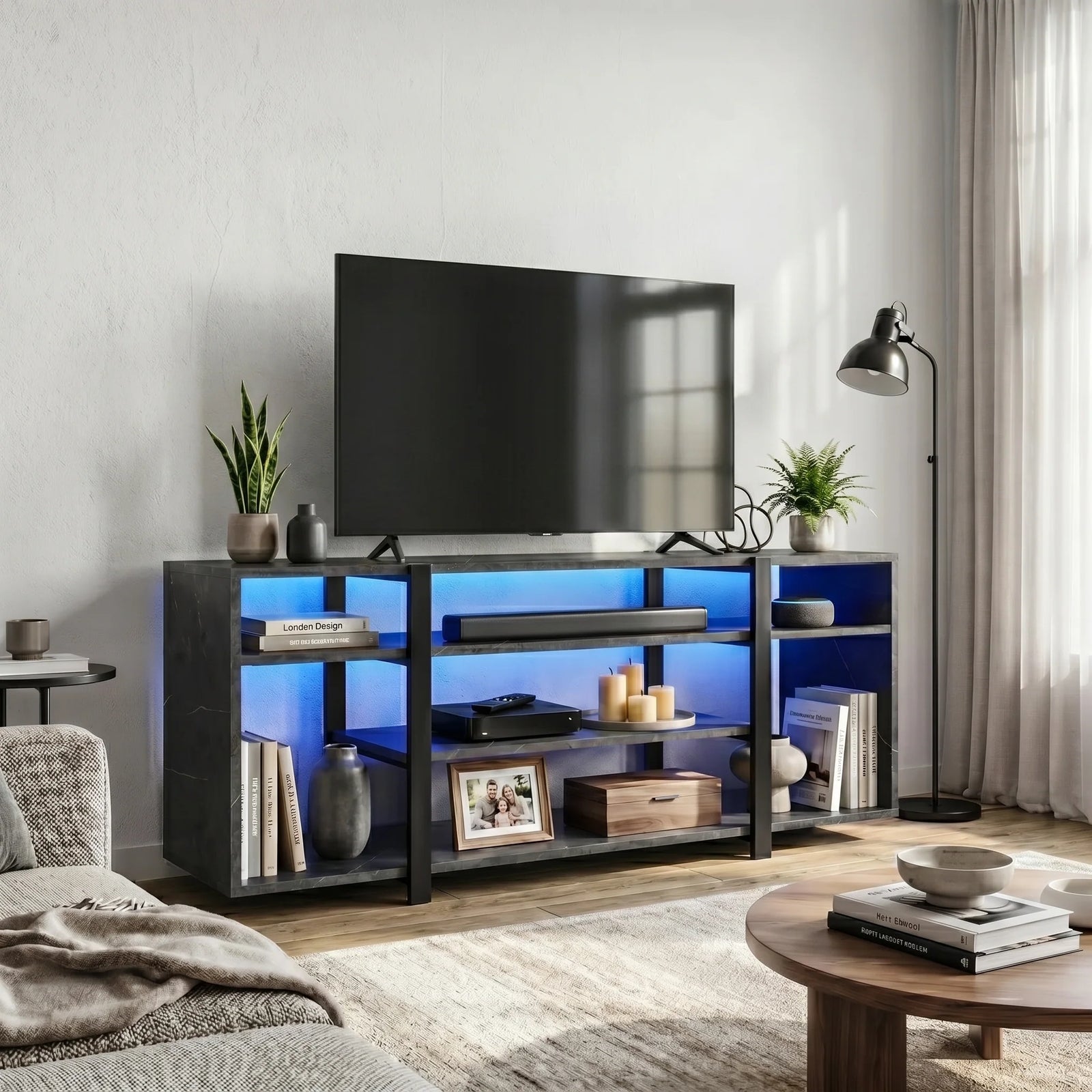 [Black Marble] LED TV Stand with Storage in a bright living room with blue LED underlighting, open shelves holding a soundbar, candles, books and a photo frame