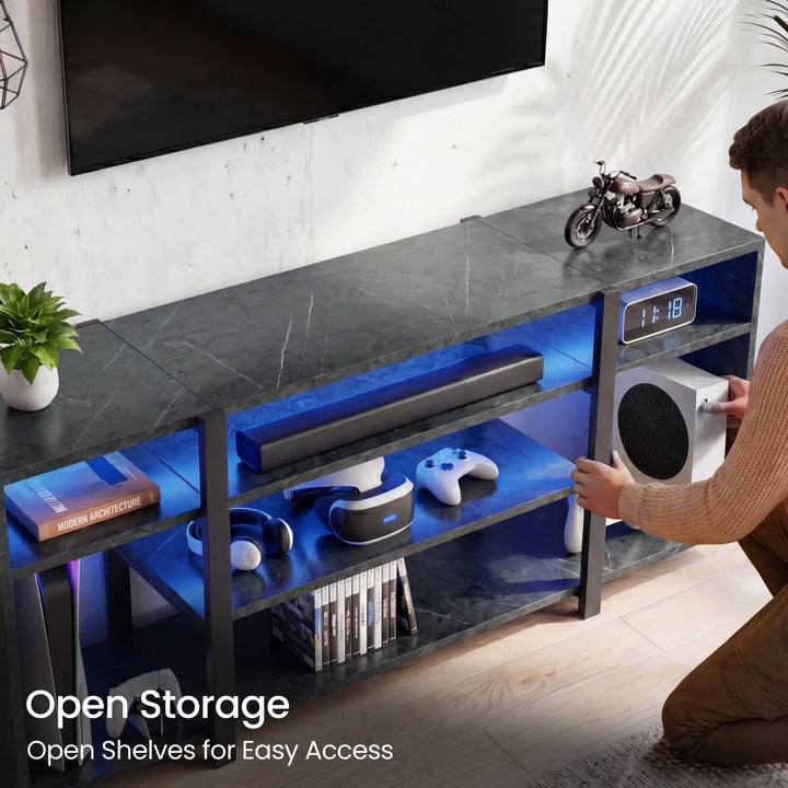 [Black Marble] Zelumi TV stand showing open shelf storage with blue LED lighting and person placing gaming console into side compartment