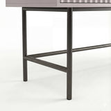 Close-up view of the black metal legs supporting the clean, modern design of a dressing table with a sturdy framework