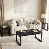 [Black] Nestline coffee table styled in a soft room with beige chairs, curtains, framed art, and rug
