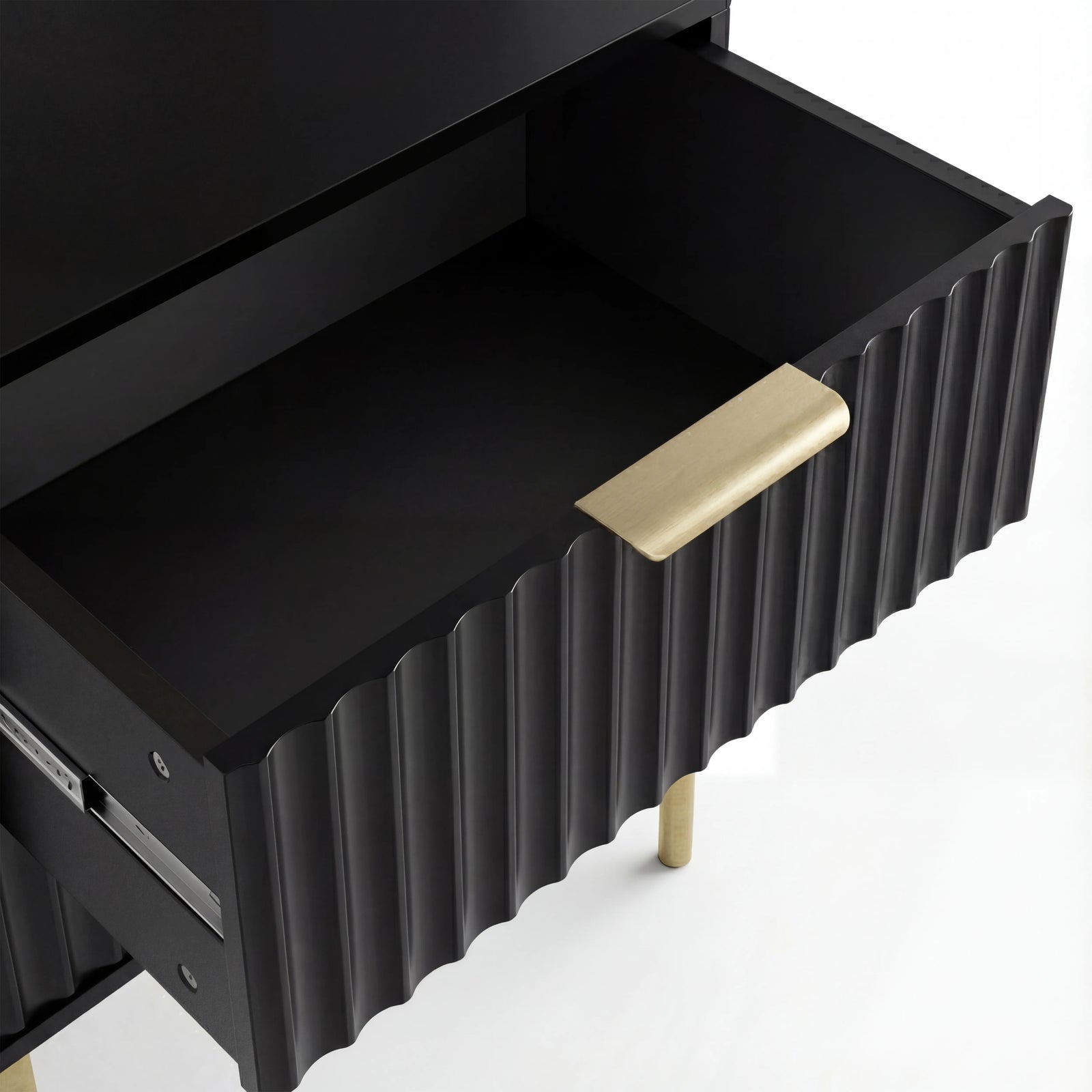 [Black] Open black flutrina bedside drawer revealing flat painted base with brushed gold bar handle on fluted front