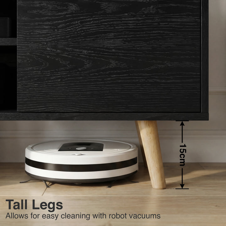 [Black] Larvik TV unit underside clearance shown with white robot vacuum sliding beneath the 15cm leg gap