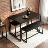 [Black] Orvak dining table and two benches in a compact industrial brick-wall setting, styled with pancakes and a white flower vase centrepiece