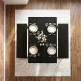 [Black] Orvak dining table seen from directly above with two benches, four place settings, cutlery, glassware, and a white rose centrepiece