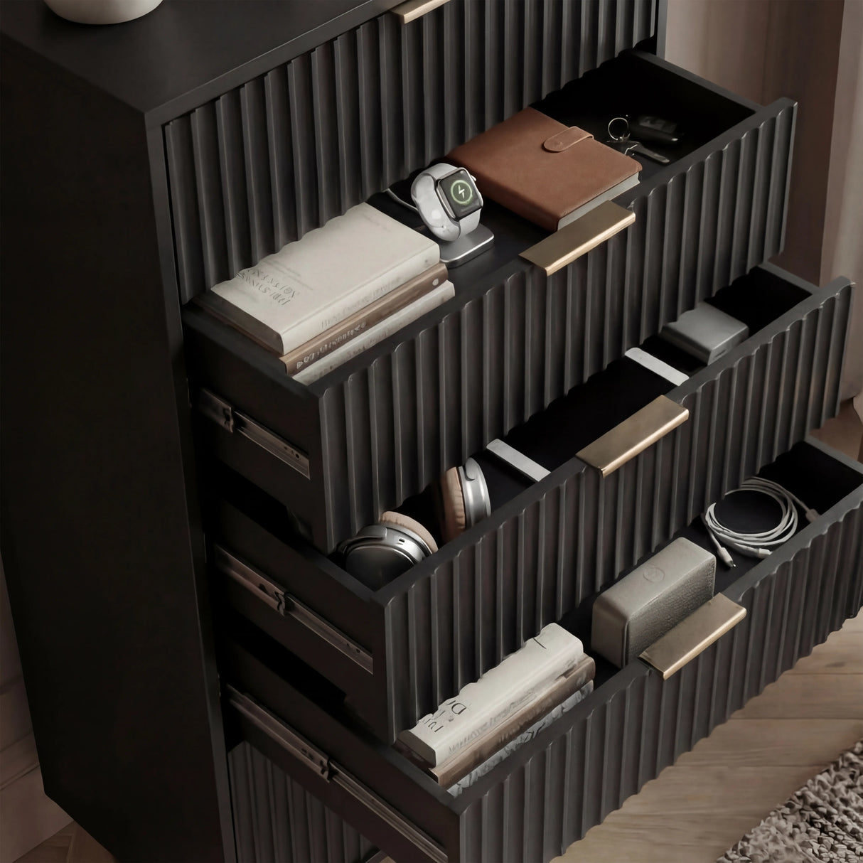 Black flutrina 5 drawer unit with drawers open to reveal interior storage compartments with golden handles