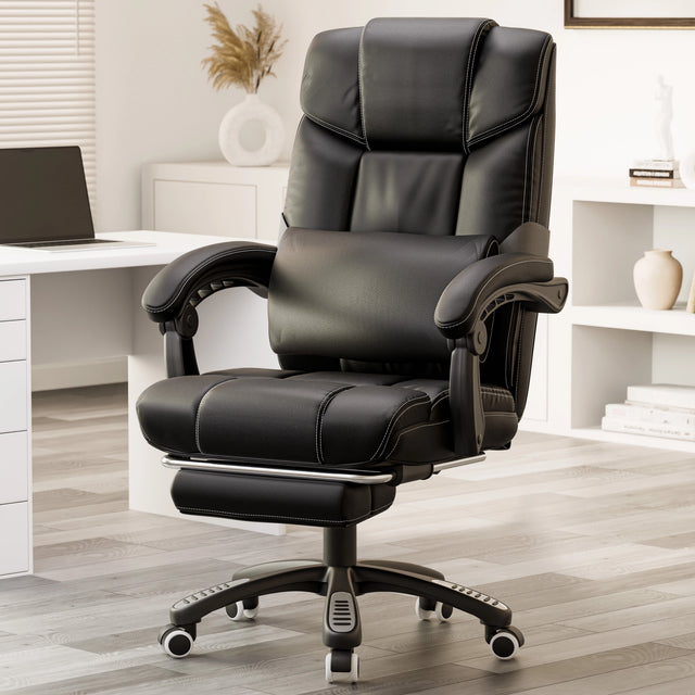 black leather office chair with footrest and lumbar pillow placed beside a wooden desk in home office