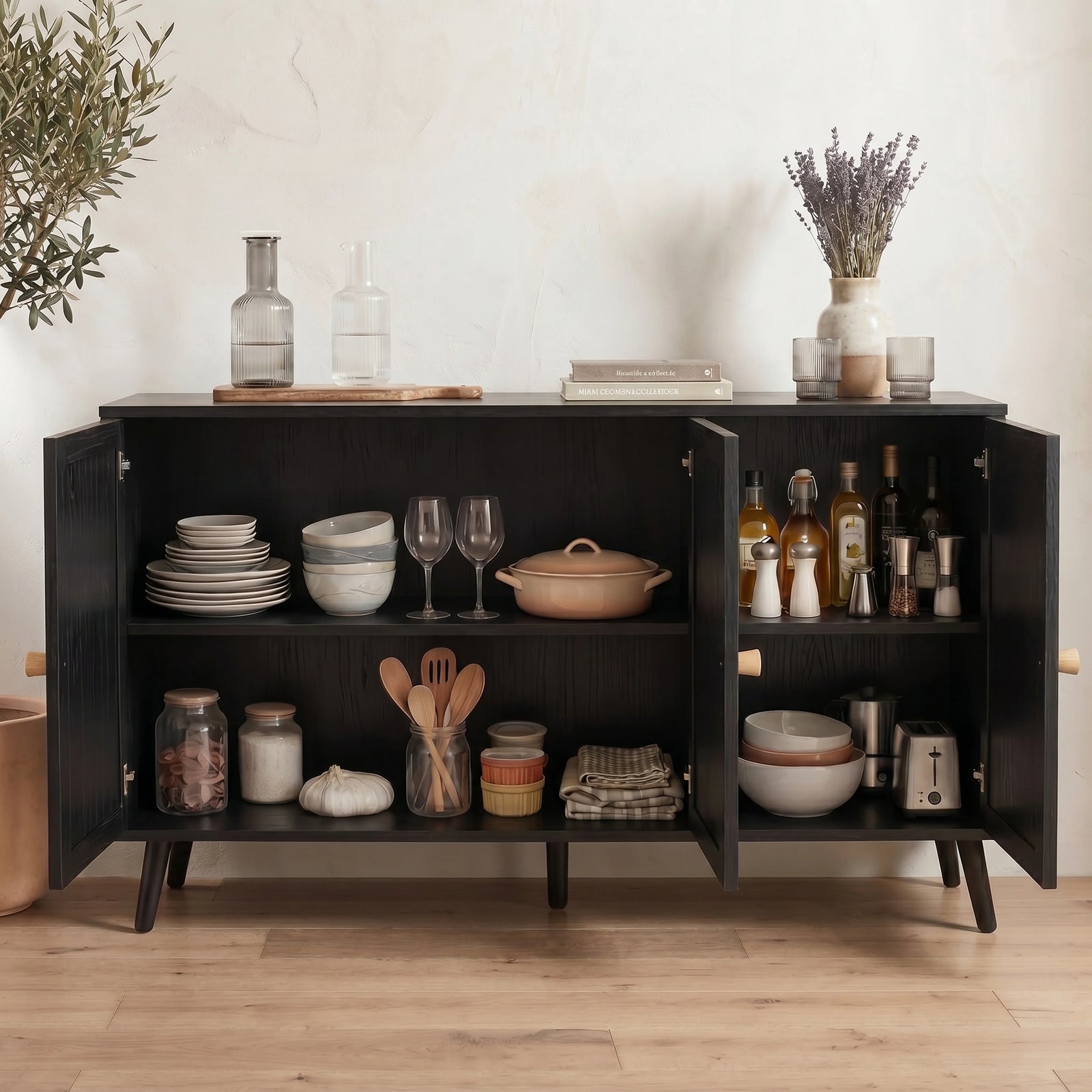 [Black] Rattan sideboard with all three doors open showing shelves styled with dishes, cookware, and pantry jars