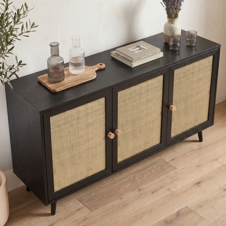 [Black] Rattan sideboard photographed from above showing wide top surface with wooden board and glass carafes