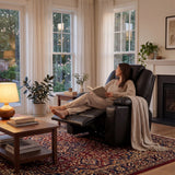 Electric Recliner Chair For Elderly | Riser Massage Armchair in black leather with heat and massage functions, placed in a cozy living room setting.