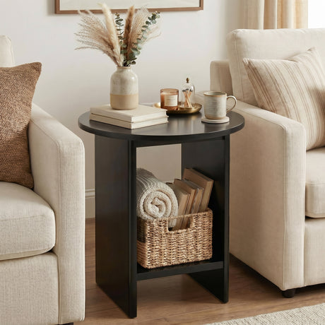 [Black] Small Round Side Table with Shelf Living Room positioned between two cream sofas with pampas vase on top and wicker basket with rolled throw on lower shelf