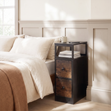 [Black + Rustic] Narrow side table with storage beside a bed, holding a lamp and small bedroom essentials