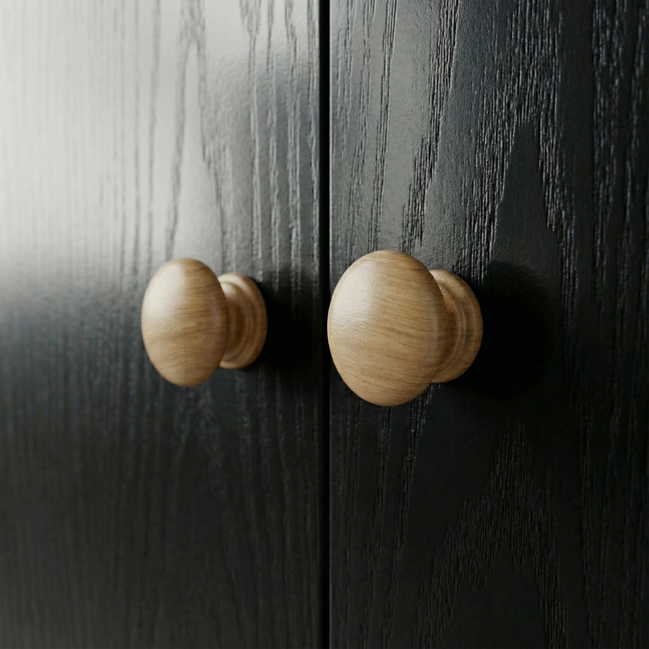 [Black] Selby wardrobe close-up of two round natural wood door knobs contrasting against black wood-effect door panels