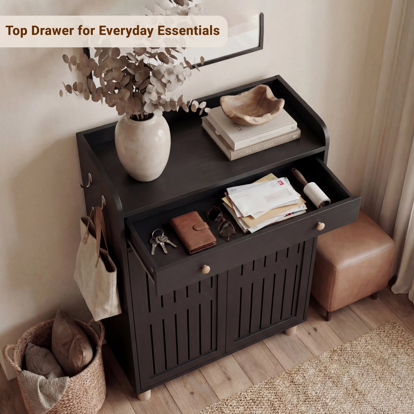 [Black] Overhead view of a shallow upper drawer holding small everyday items positioned above a multi-shelf black footwear cabinet