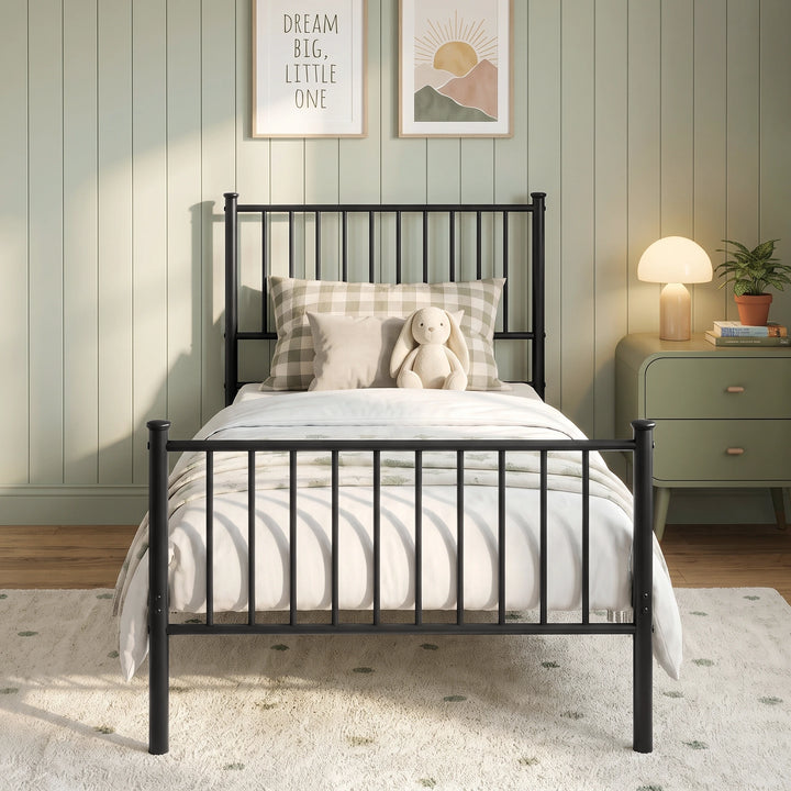 [Black | Single] Front view showing bar headboard and footboard, checked pillow, toy bunny, bedding, bedside lamp, and plant.
