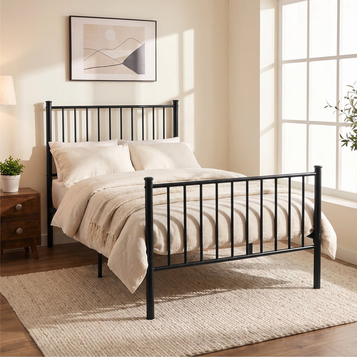 [Black | Single] Angled view of metal bed with white bedding, bar ends, centre leg, wooden nightstand, plant & bright window.