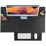 overhead shot of a compact computer desk in black featuring monitor, phone, tray, and headphones—perfect for small home offices