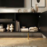 Black TV cabinet with open central shelving and fluted doors, showcasing organized storage for media and home decor.